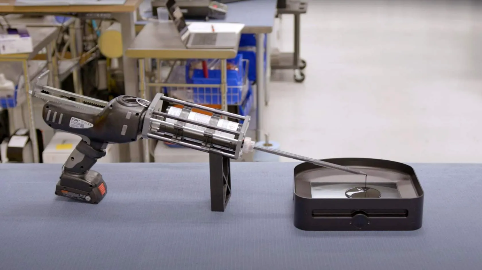 Dispenser pushing resin through a mixing tip into an M2 cassette.