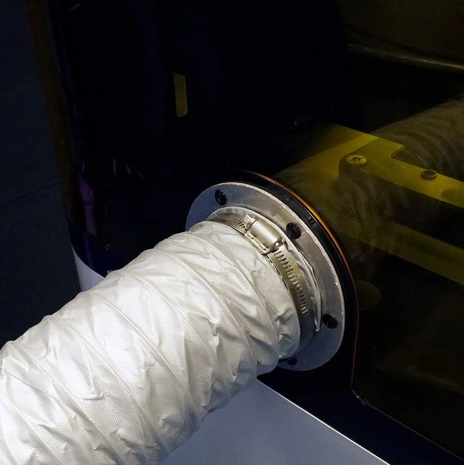 Ventilation hose connected to back of printer Ventilation hose connected to back of printer