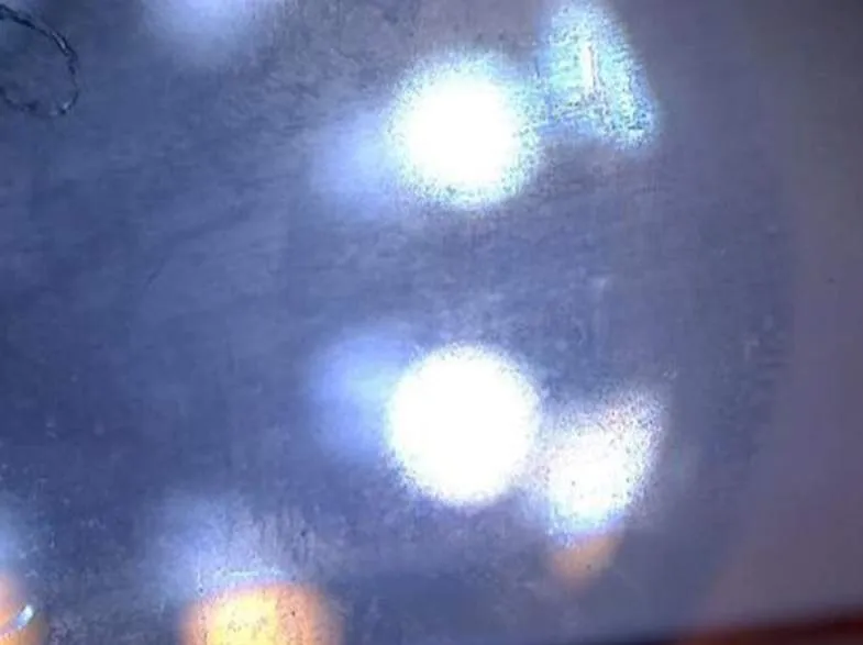 A) Hazy underside of window.