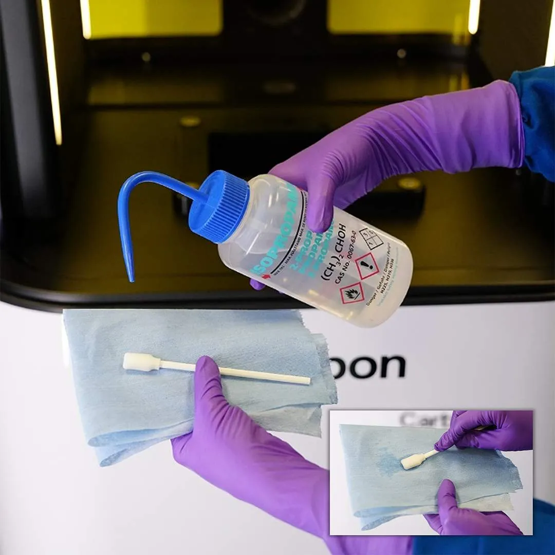 Dampen a swab with IPA outside of printer Dampen a swab with IPA outside of printer